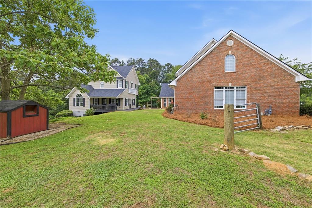 4337 Mountain View Road Oakwood, GA 30566 - Photo 66 of 84 a front view of a house with a yard and garage