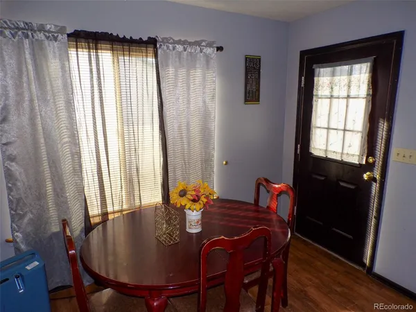 a dining room with furniture and window