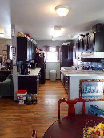 a room with furniture a rug kitchen view and a counter top space