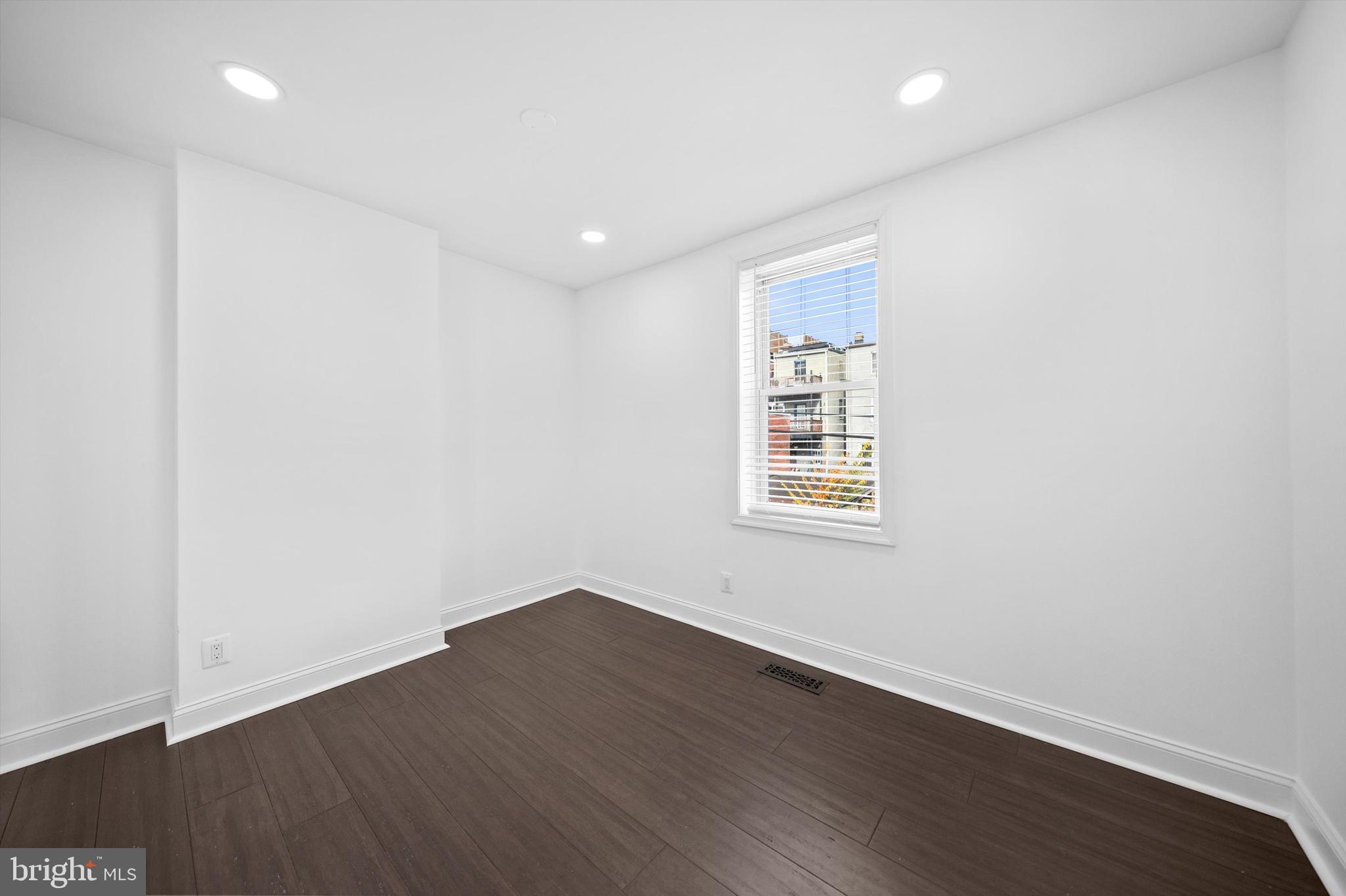 65 Bates Street Northwest Washington, DC 20001 - Photo 18 of 23 an empty room with wooden floor and windows