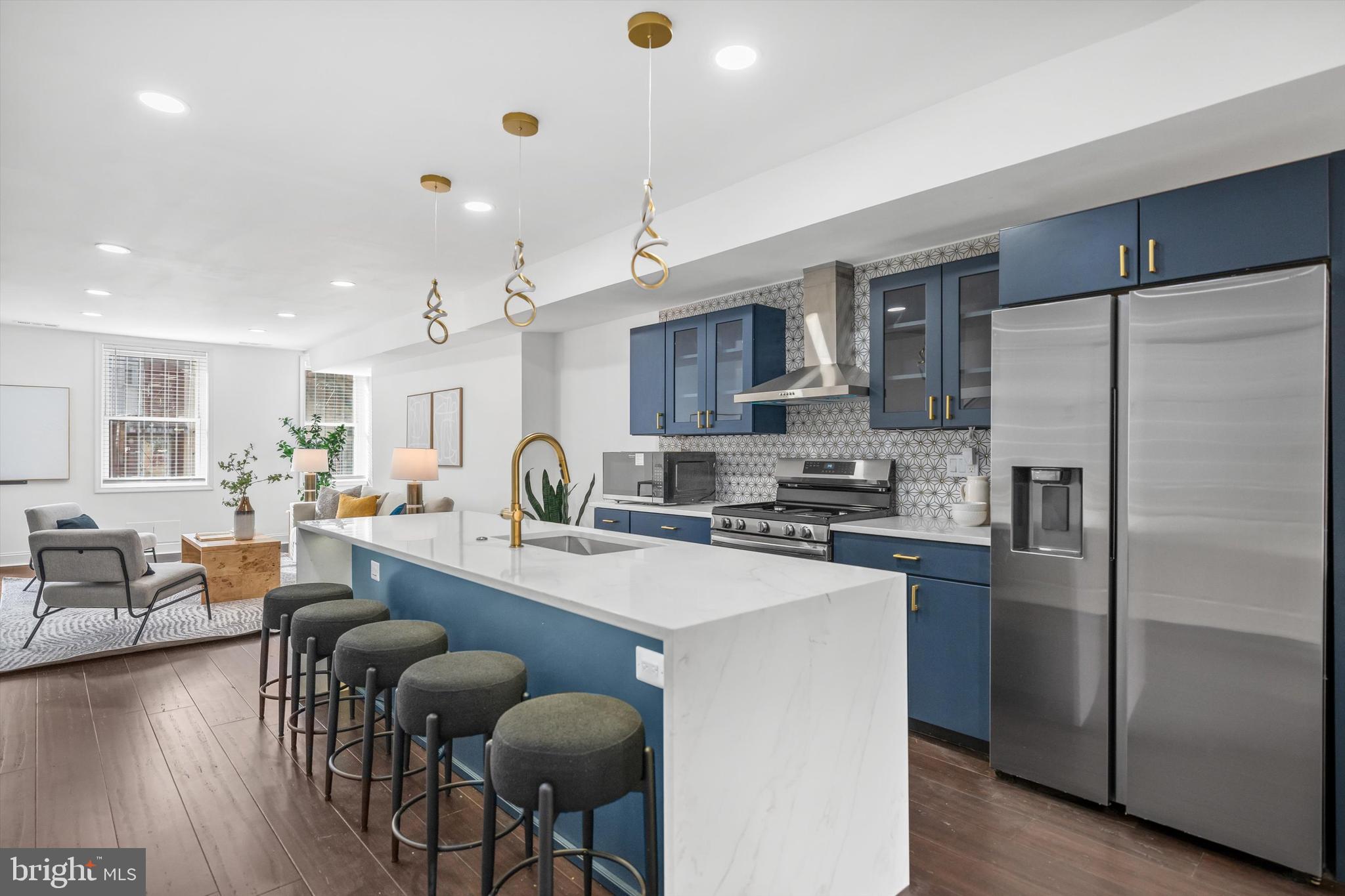 65 Bates Street Northwest Washington, DC 20001 - Photo 6 of 23 a kitchen with refrigerator a stove a dining table and chairs
