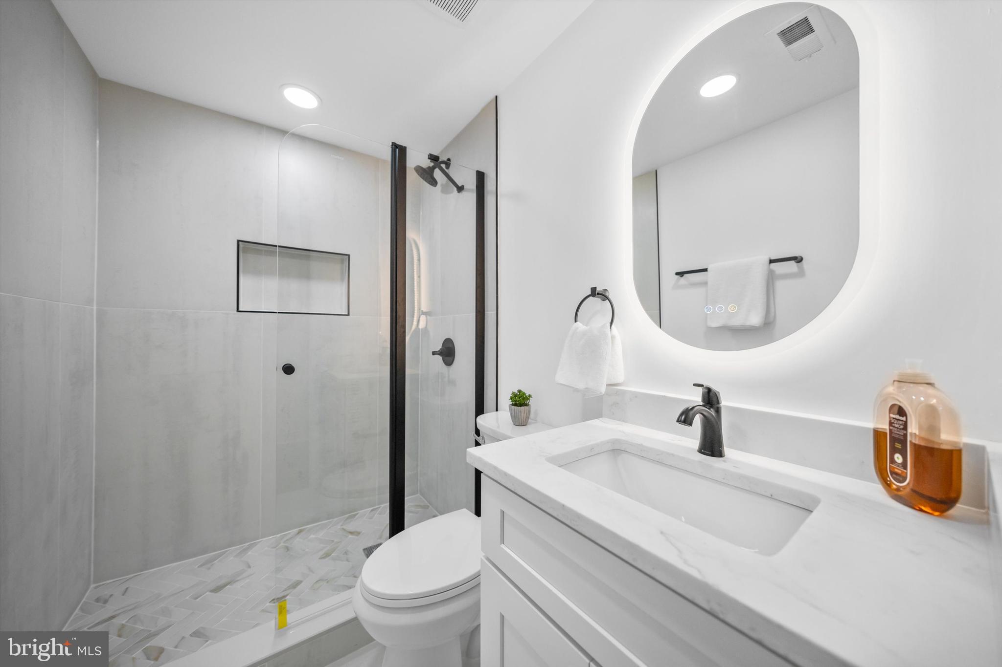 65 Bates Street Northwest Washington, DC 20001 - Photo 8 of 23 a bathroom with a sink a toilet and shower