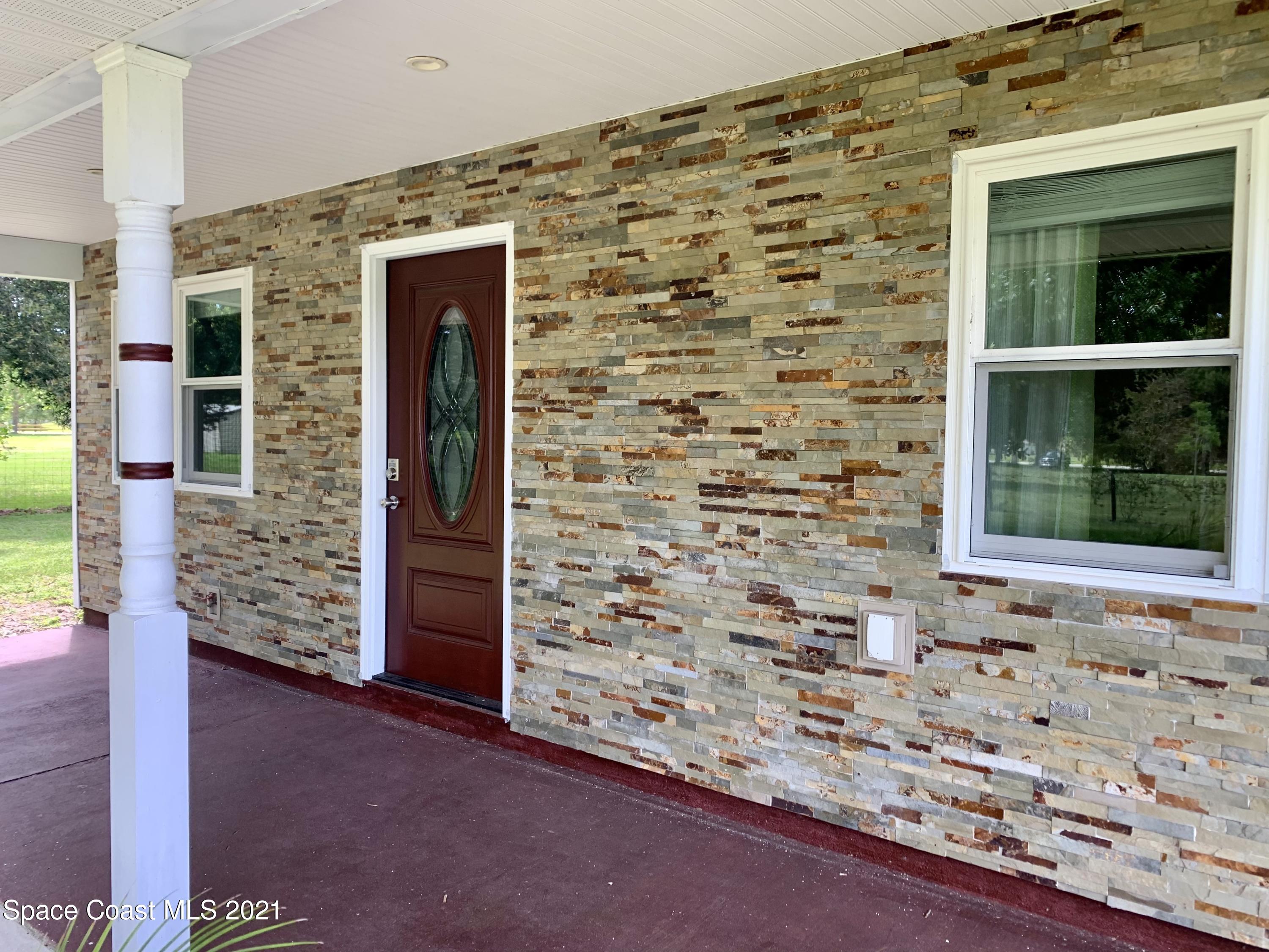 3155 Lionel Road Mims, FL 32754 - Photo 3 of 61 stacked stone on front