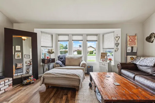 a bedroom with bed and wooden floor