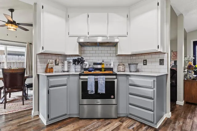a kitchen with stainless steel appliances granite countertop a refrigerator stove and sink