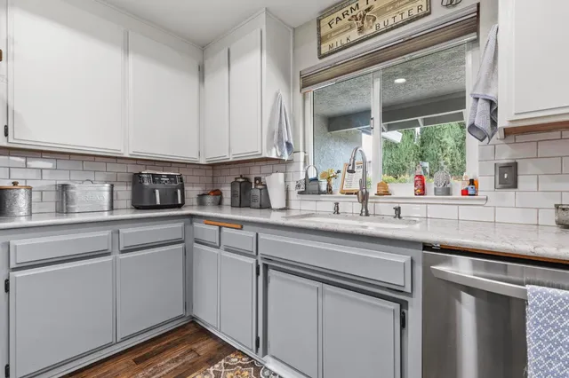 a kitchen with a sink and cabinets