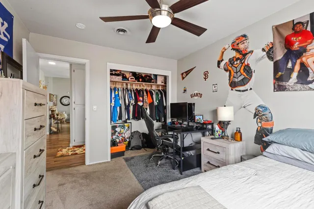 a bedroom with a bed and a book shelf