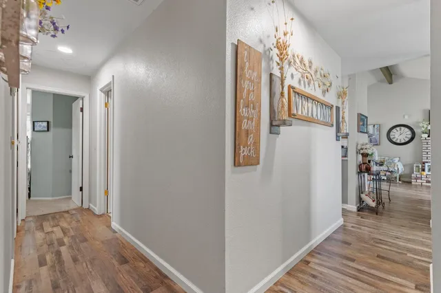 a view of a hallway and dining room with wooden floor
