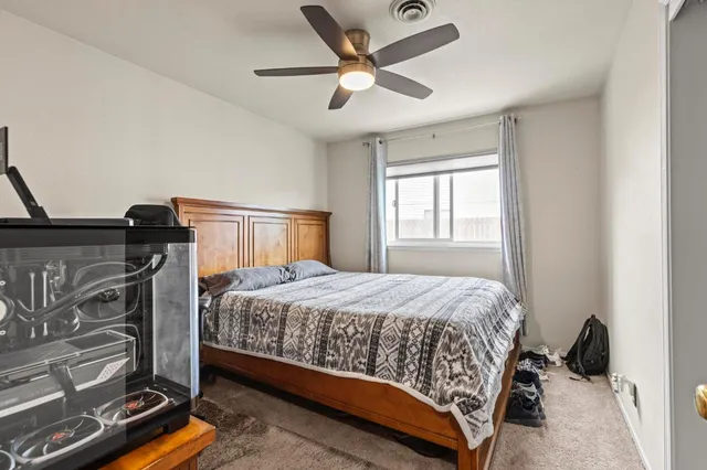 a bedroom with a bed and a window