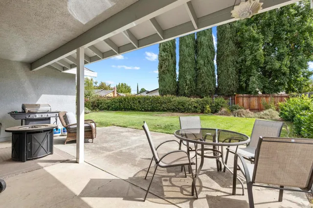 a patio with a yard table and chairs