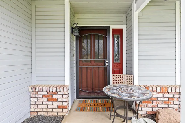 a view of a porch with a table and chairs