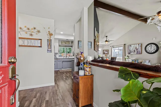 a living room with furniture and a mirror