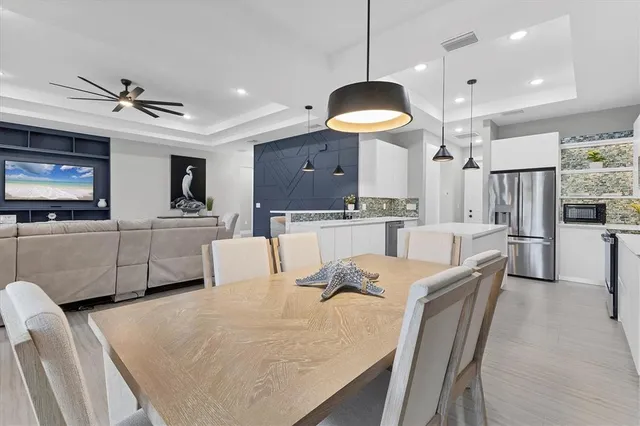 a kitchen with kitchen island a sink stainless steel appliances and refrigerator