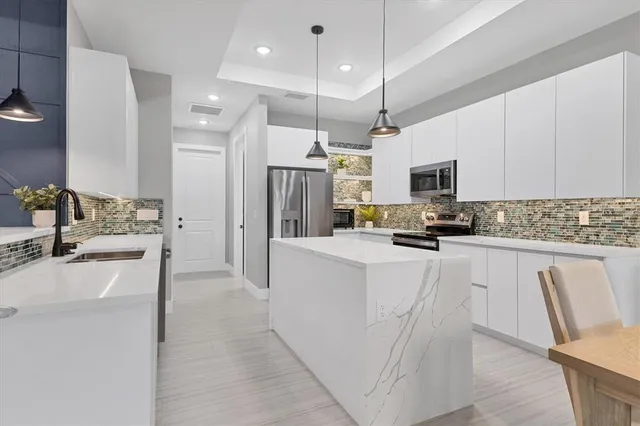 a bedroom with a bed and painting on the wall