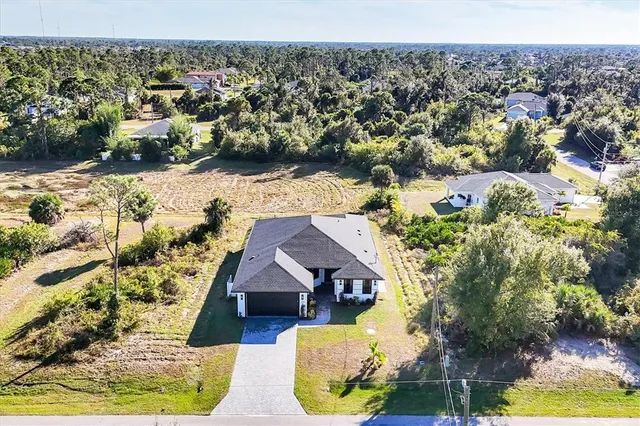 an aerial view of a house with yard swimming pool and outdoor seating