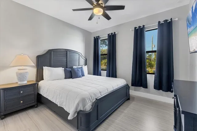 a bedroom with a bed and painting on the wall