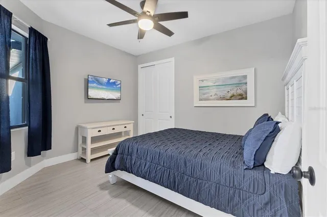 a bedroom with a large bed and a chandelier