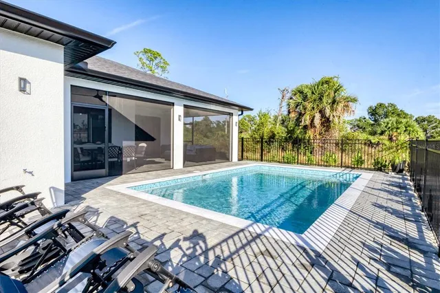 a view of swimming pool with outdoor seating and plants