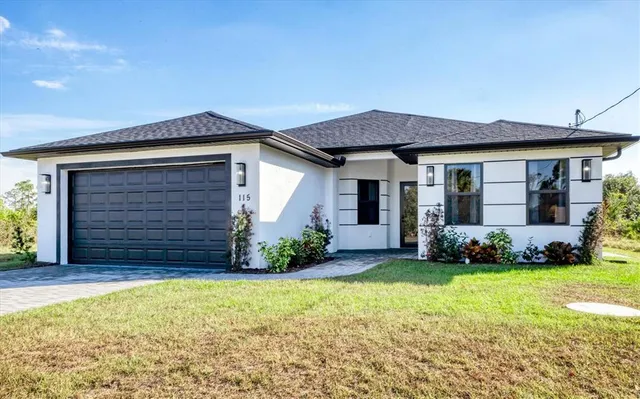 a view of a house with backyard and porch