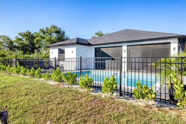 a view of a house with backyard porch and sitting area