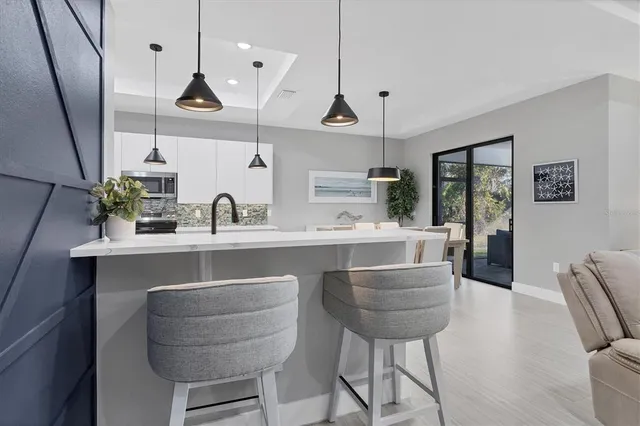 a kitchen with kitchen island cabinets and chairs