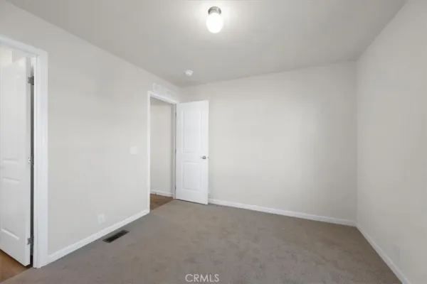 a bathroom with a toilet and a window