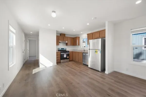 a kitchen with refrigerator a stove a microwave and cabinets
