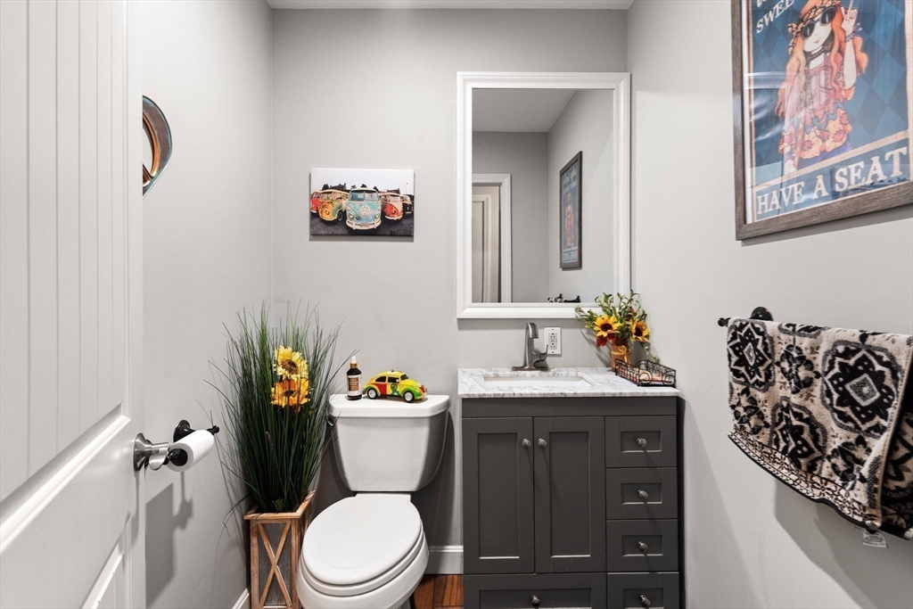 12 Dixfield Road Worcester, MA 01606 - Photo 14 of 42 a bathroom with a granite countertop toilet sink and mirror