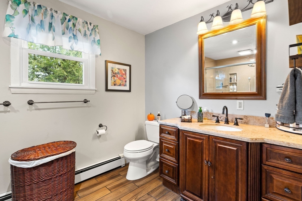 12 Dixfield Road Worcester, MA 01606 - Photo 27 of 42 a bathroom with a toilet a sink and a mirror