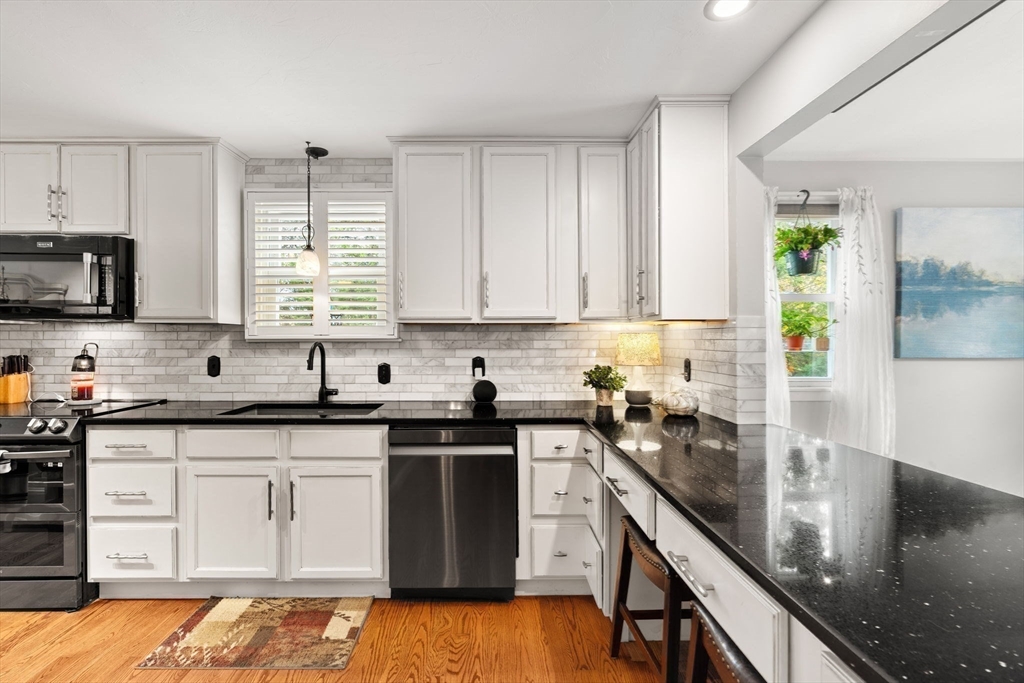 12 Dixfield Road Worcester, MA 01606 - Photo 9 of 42 a kitchen with stainless steel appliances granite countertop a sink a stove and cabinets