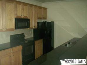 2135 Midnight Blue Lane, Unit 2135 Fort Mill, SC 29708 - Photo 3 of 7 a kitchen with a refrigerator and a stove top oven