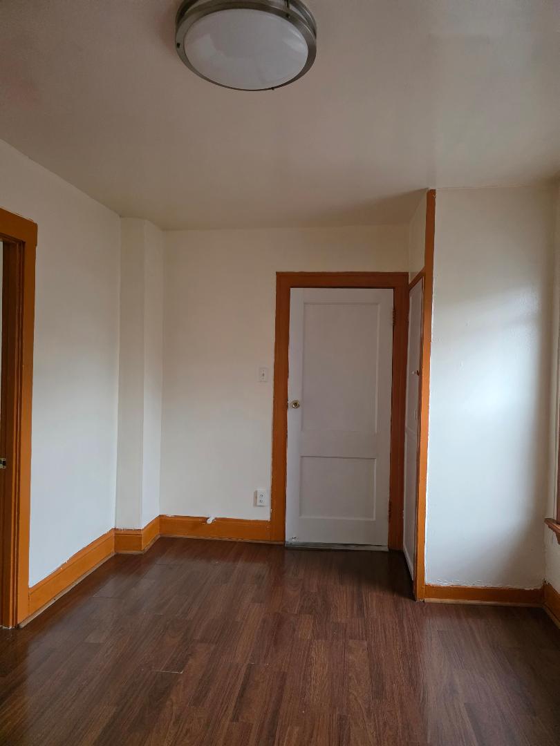 2632 South Princeton Avenue, Unit 2 Chicago, IL 60616 - Photo 12 of 13 an empty room with wooden floor and windows
