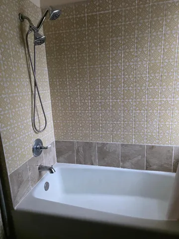 a bathroom with a tub and a shower