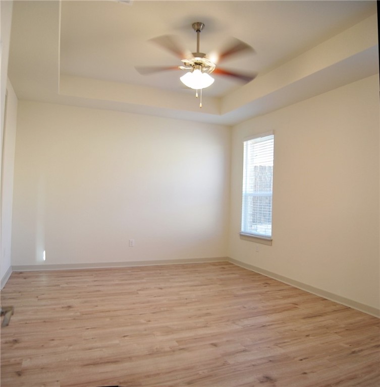 640 Peace Pipe Way Georgetown, TX 78628 - Photo 11 of 24 wooden floor in an empty room with a window
