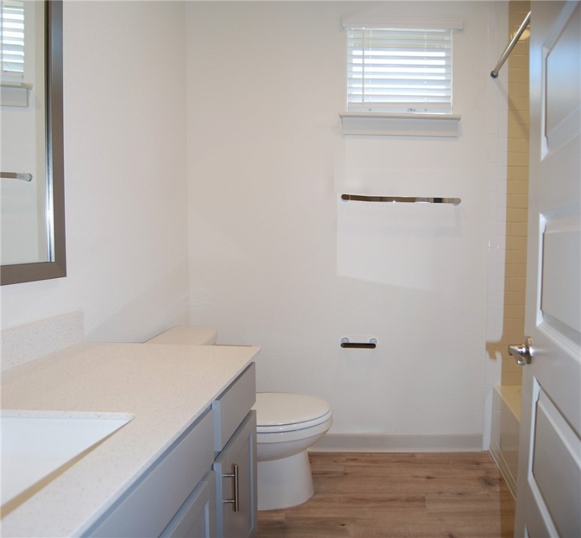 640 Peace Pipe Way Georgetown, TX 78628 - Photo 19 of 24 a bathroom with a granite countertop toilet and a sink