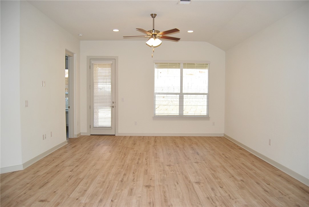 640 Peace Pipe Way Georgetown, TX 78628 - Photo 5 of 24 wooden floor in an empty room with a window