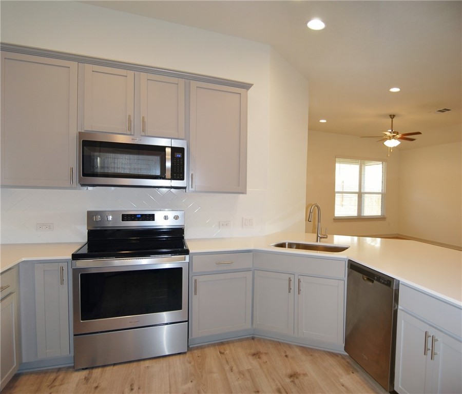 640 Peace Pipe Way Georgetown, TX 78628 - Photo 9 of 24 a kitchen with a stove and a sink