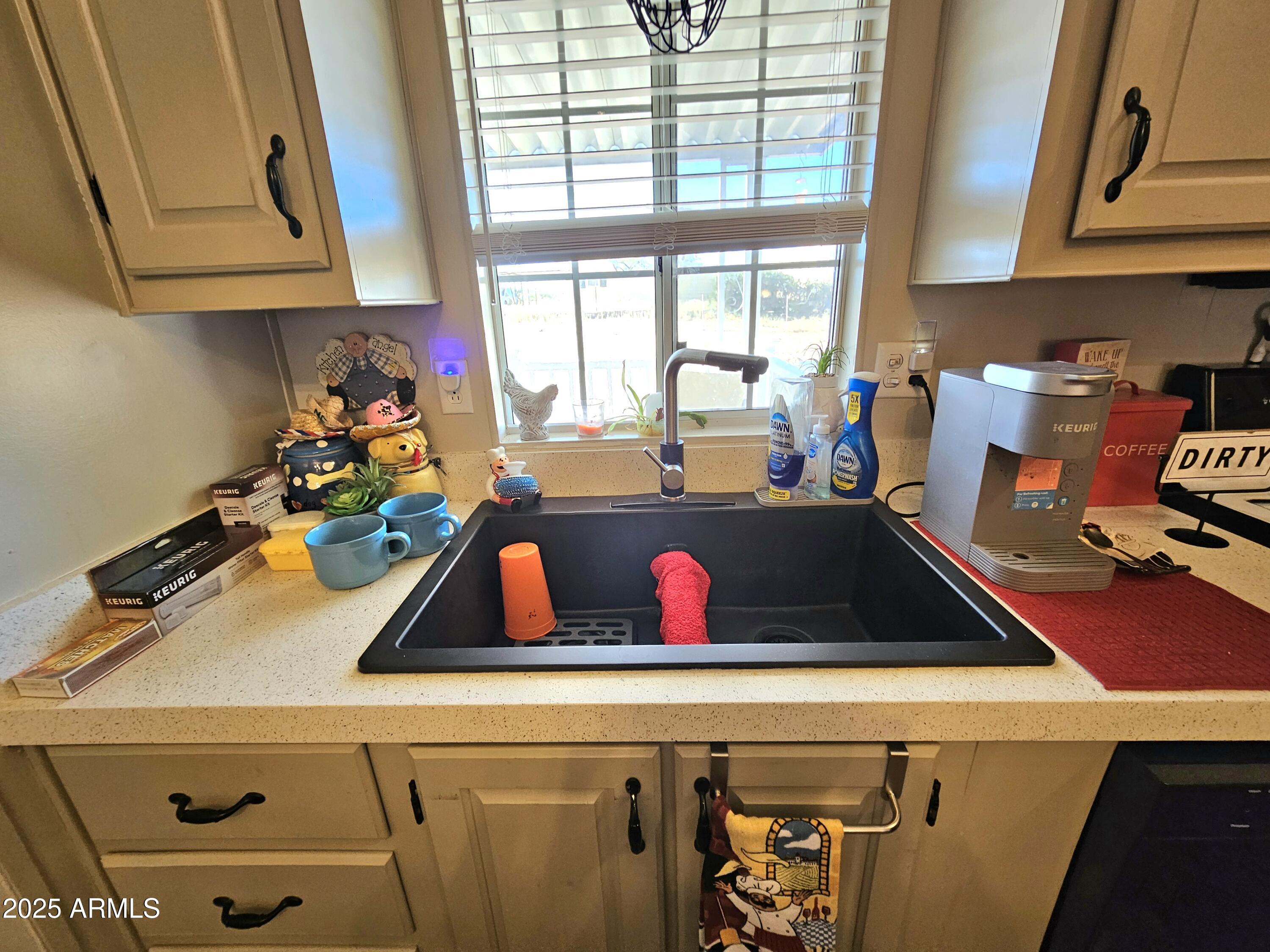 284 North Warren Road Benson, AZ 85602 - Photo 11 of 33 a view of a kitchen with a window a sink and cabinets