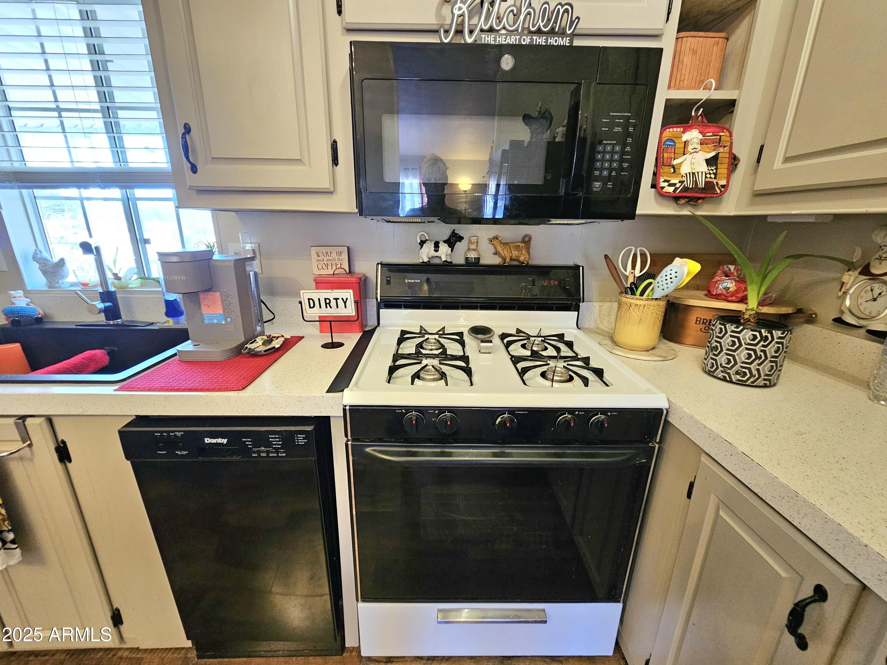 284 North Warren Road Benson, AZ 85602 - Photo 12 of 33 a kitchen with a stove and a refrigerator