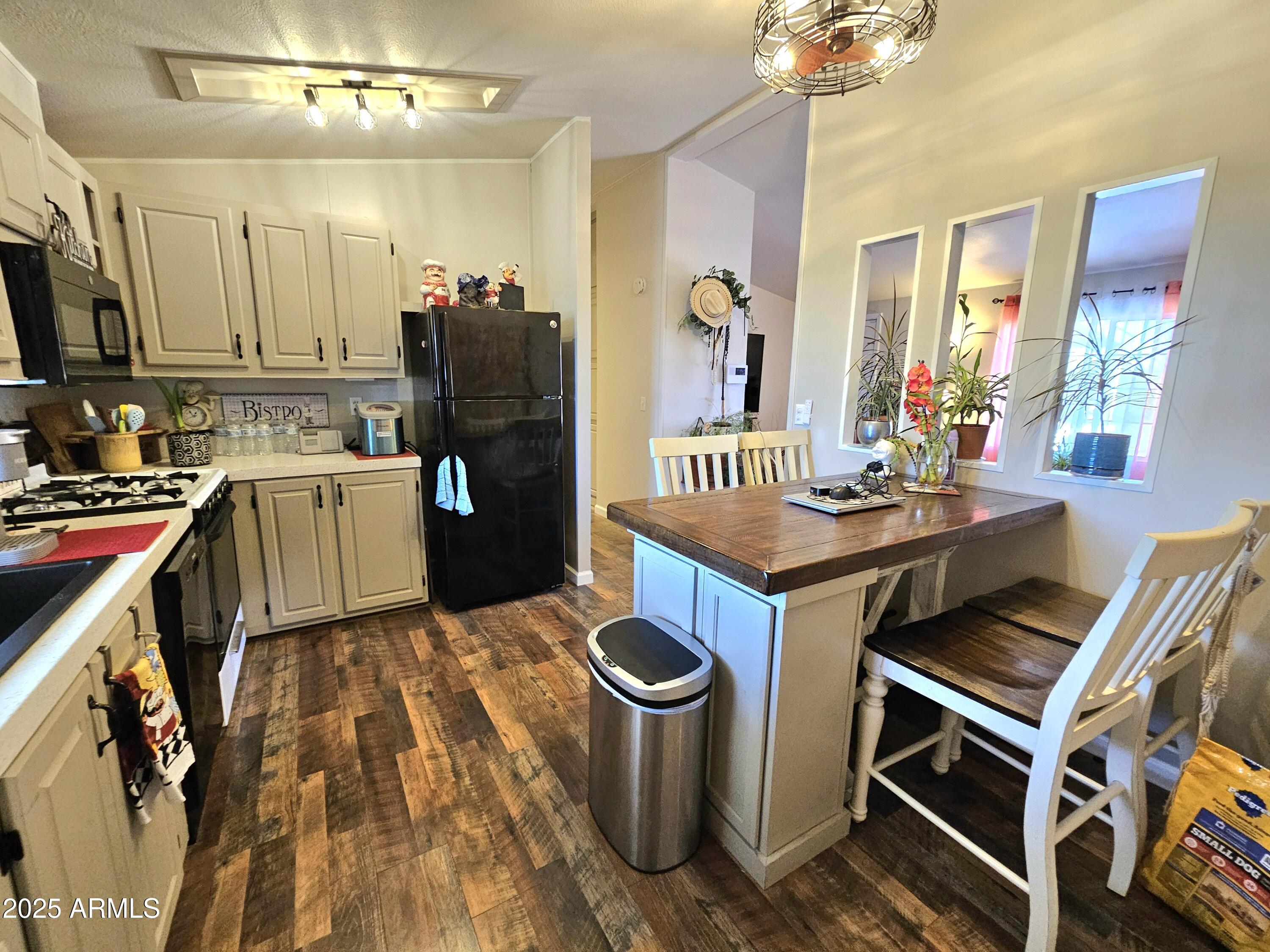 284 North Warren Road Benson, AZ 85602 - Photo 13 of 33 a kitchen with a stove and a refrigerator