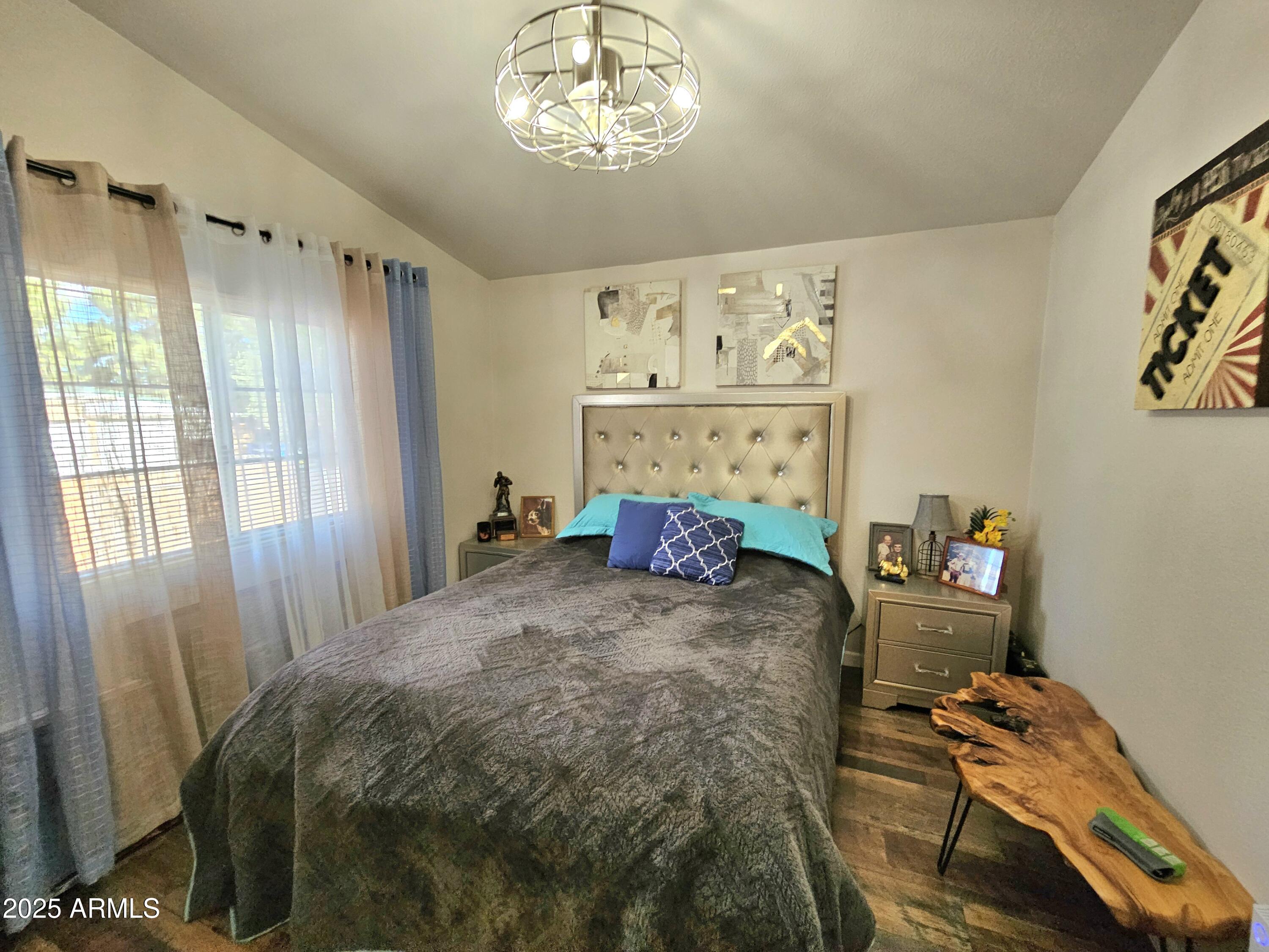 284 North Warren Road Benson, AZ 85602 - Photo 16 of 33 a bed sitting in a bedroom next to a window