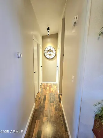 a kitchen with stainless steel appliances granite countertop a sink dishwasher a stove and a dining table with wooden floor