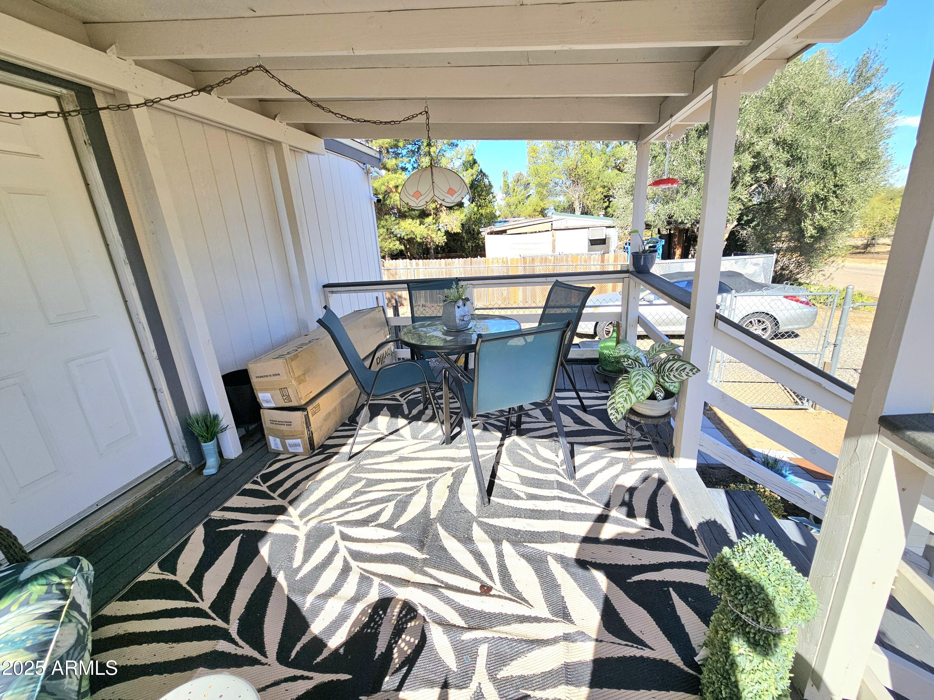284 North Warren Road Benson, AZ 85602 - Photo 27 of 33 a view of a patio with a table chairs and a backyard