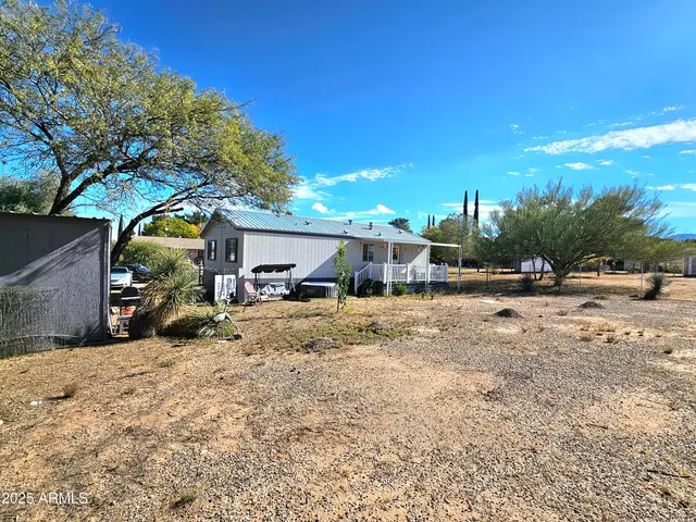 a view of a house with a yard covered in snow