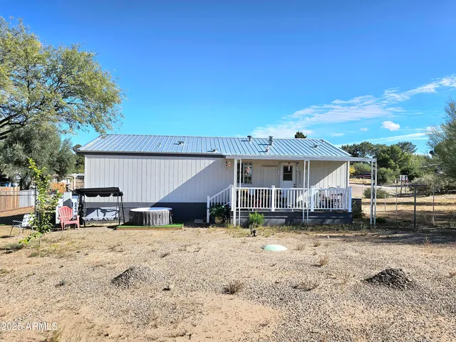 a living room with furniture and large windows