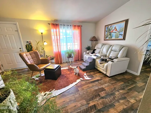a kitchen with a table chairs and refrigerator