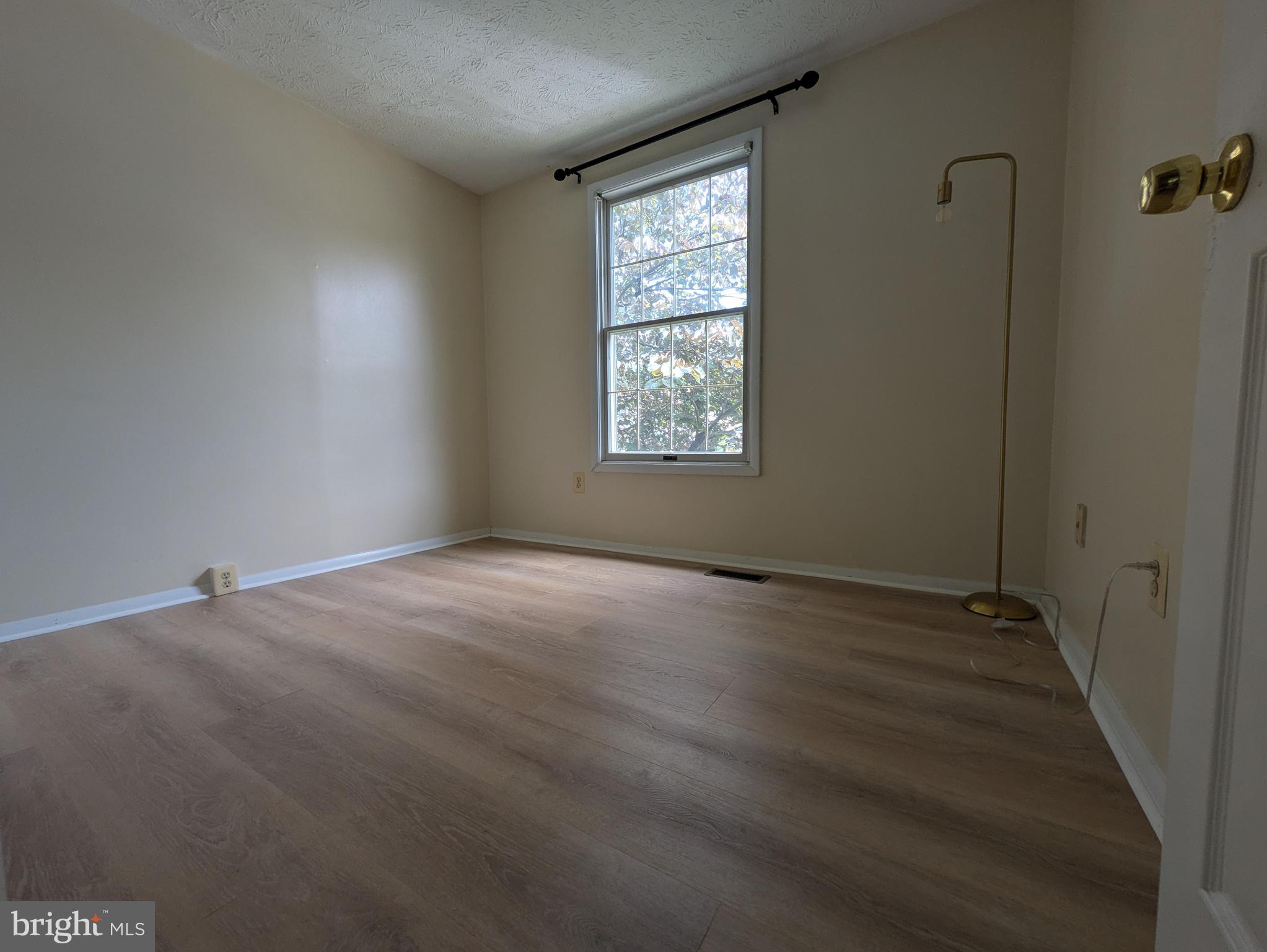7993 Tyson Oaks Circle Vienna, VA 22182 - Photo 14 of 25 an empty room with wooden floor and windows