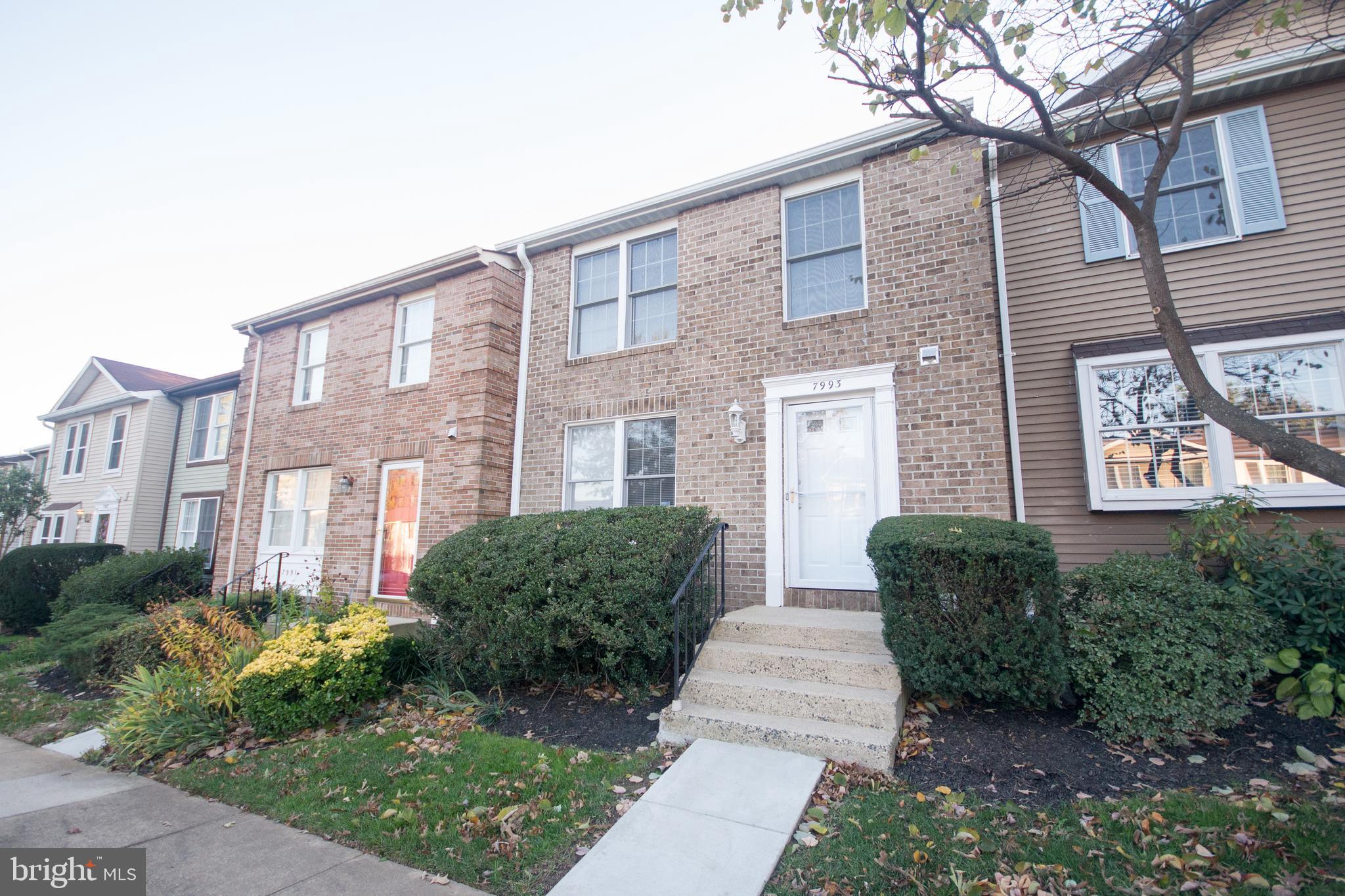 7993 Tyson Oaks Circle Vienna, VA 22182 - Photo 2 of 25 a front view of a house with garden
