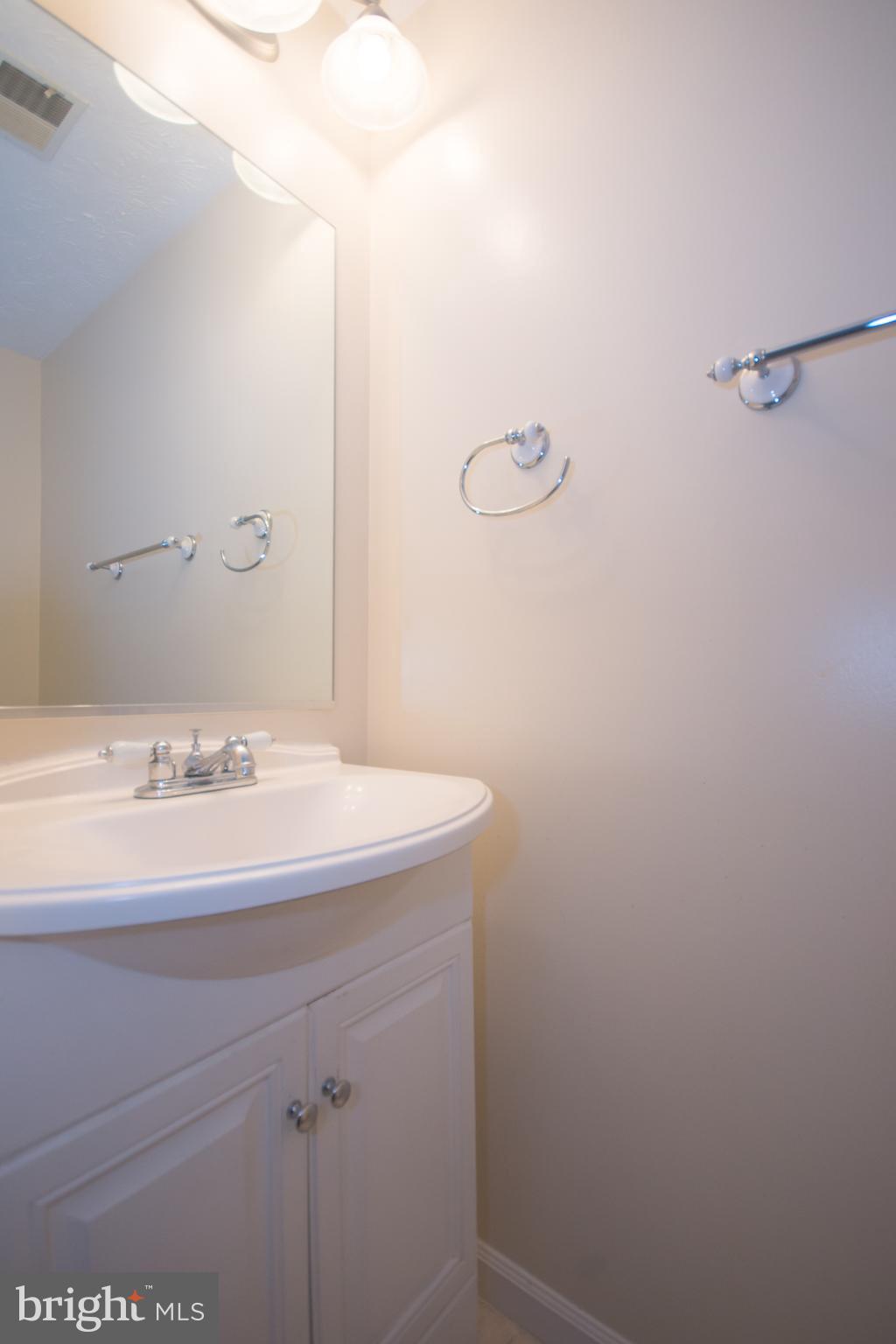 7993 Tyson Oaks Circle Vienna, VA 22182 - Photo 21 of 25 a bathroom with a sink and vanity