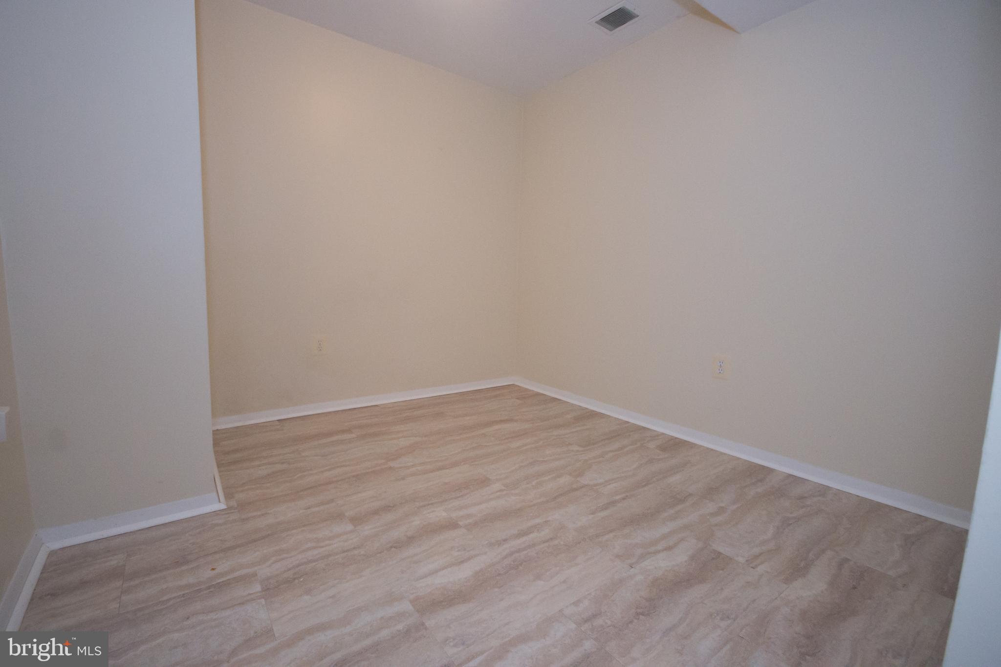 7993 Tyson Oaks Circle Vienna, VA 22182 - Photo 22 of 25 a view of an empty room with wooden floor